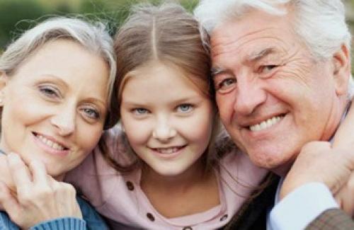 Young girl posing with her grandparents